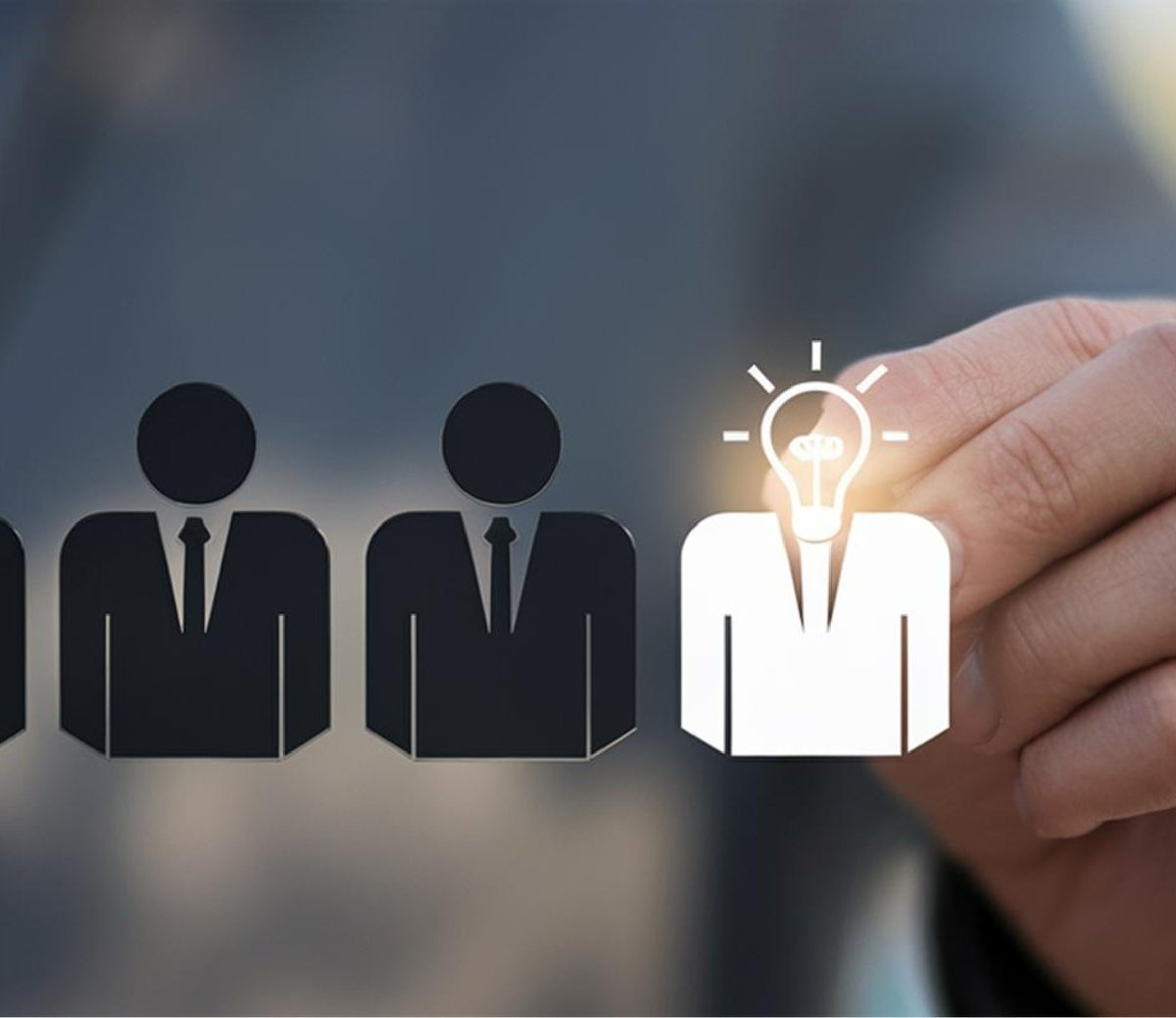 Row of business figures with one highlighted by a glowing light bulb